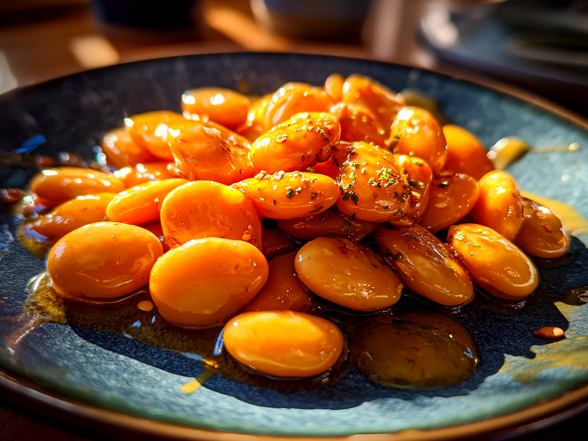 Finished creamy miso butter beans with fresh garnish and natural shadows
